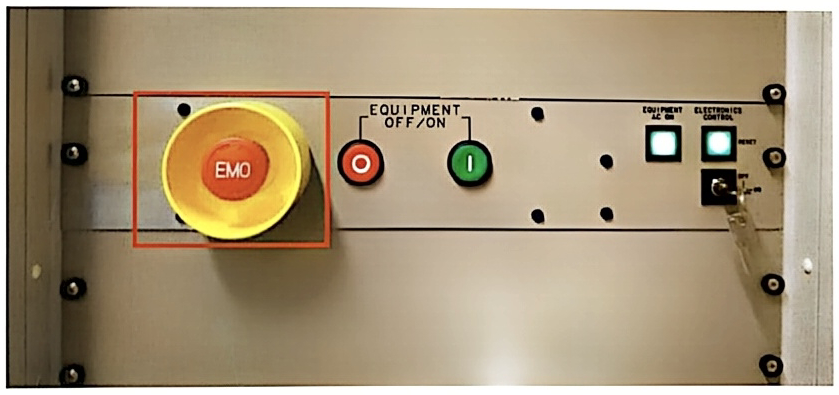 Emergency stop (EMO) button on the vacuum cabinet, marked with a red box